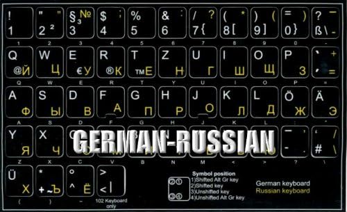 Njemačke ruske naljepnice na tastaturi na crnoj pozadini netransparentne za radnu površinu, laptop i bilježnicu
